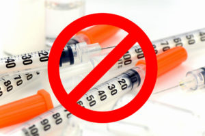 Insulin syringe with 29G. needle on white background.