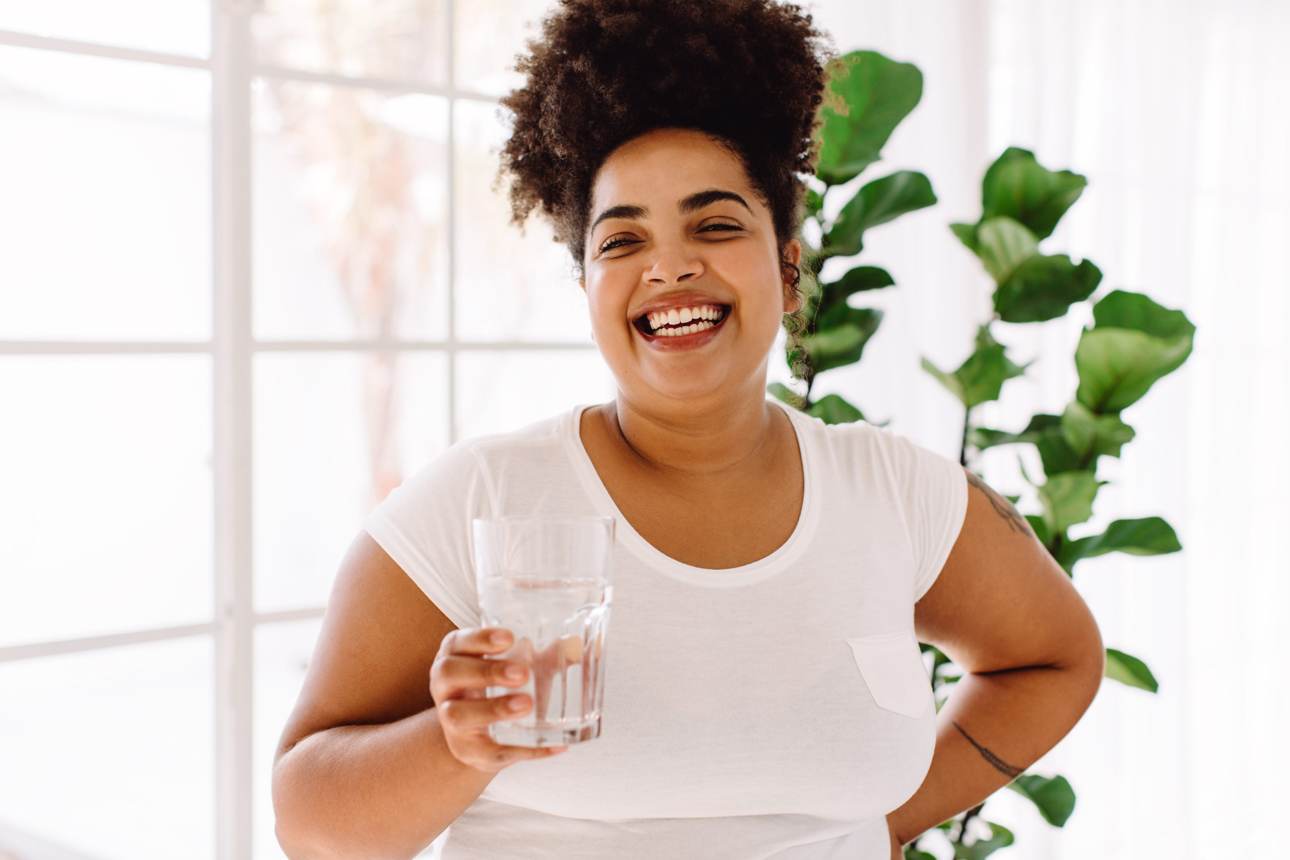 a bariatric patient drinks water and smiles while preparing for weight loss surgery