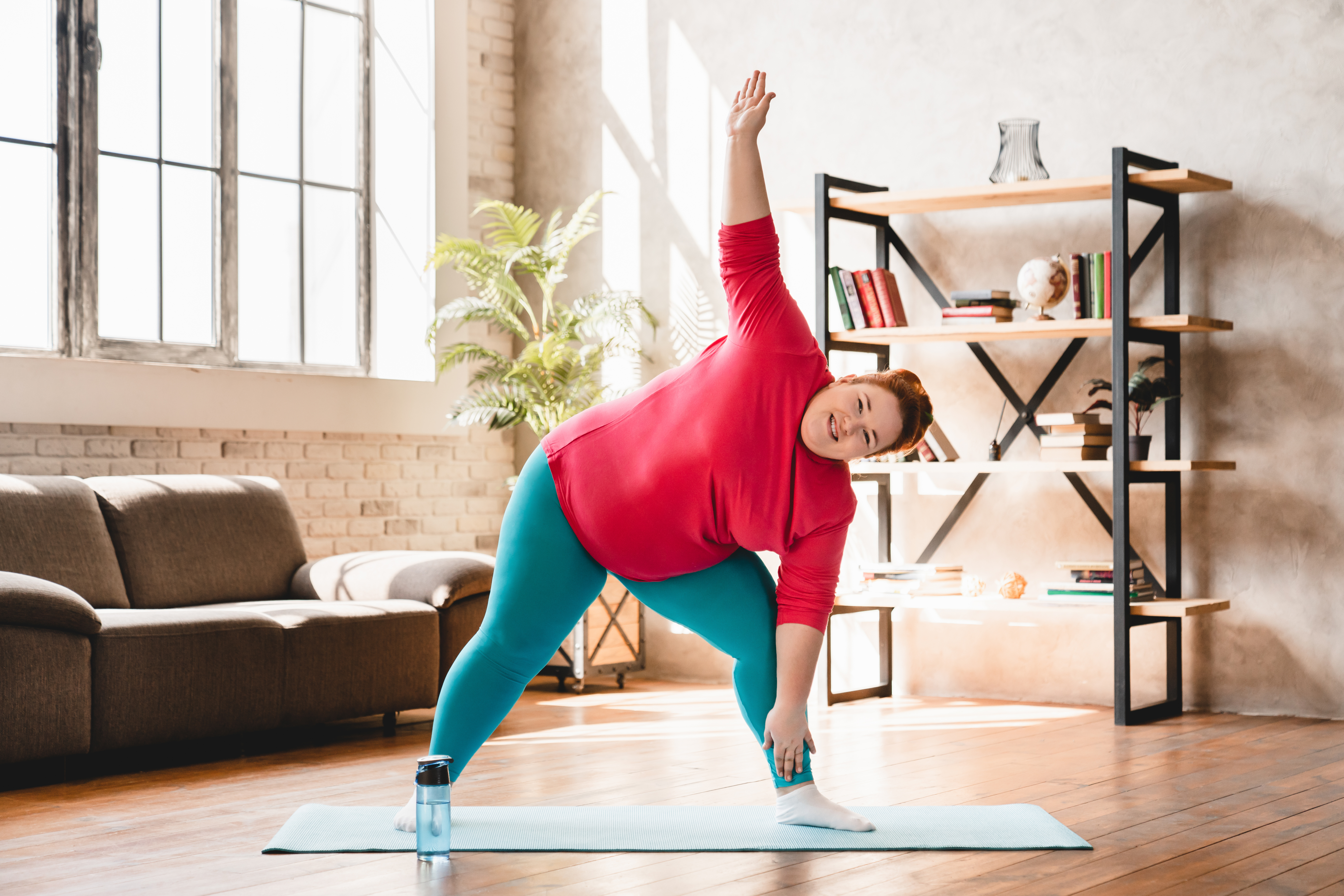 bariatric patient practicing yoga in home gym