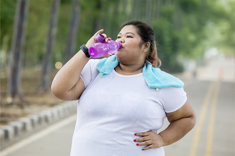 a bariatric patient drinks water to stay hydrated after bariatric surgery