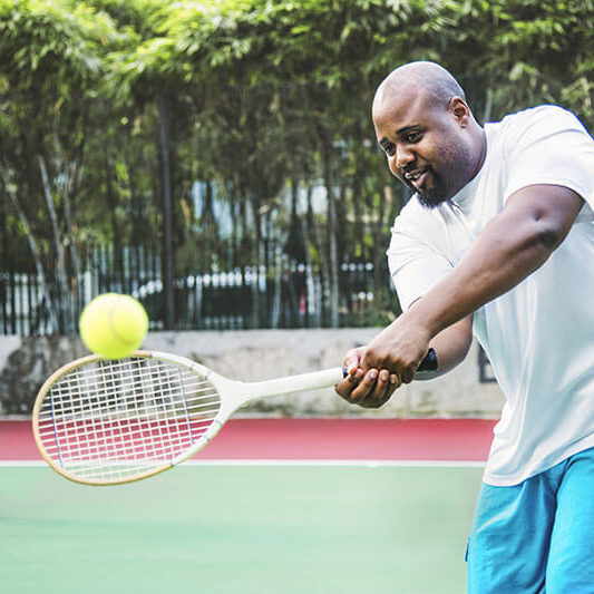 bariatric patients playing tennis on court