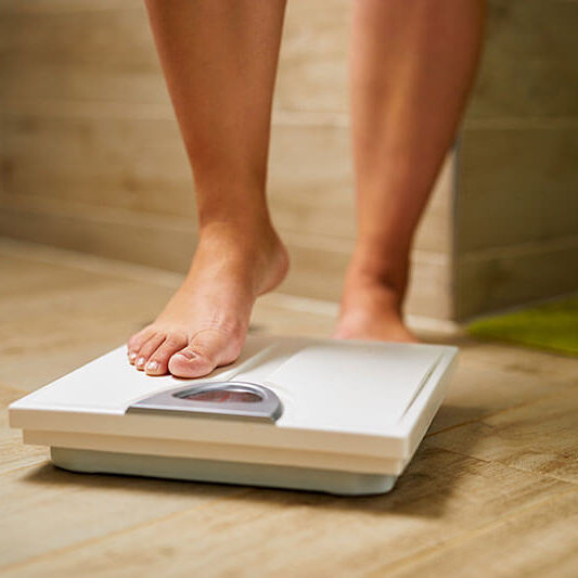 bariatric patient is stepping onto scale